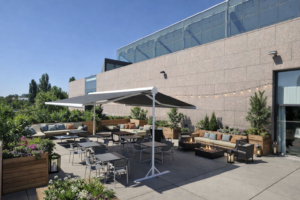 Stores verticaux coffre screen orange installés sur une façade moderne pour protection solaire terrasse